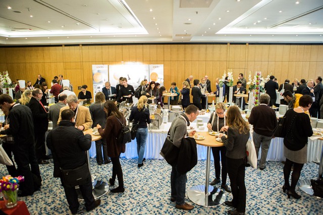 Delegates talking in a busy exhibition area