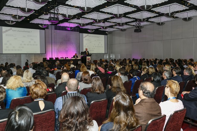 A full auditorium listening to a lecture
