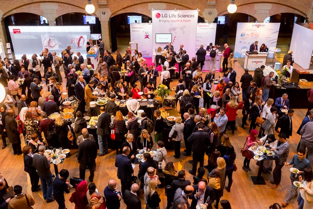 Delegates networking in an exhibition hall, seen from above